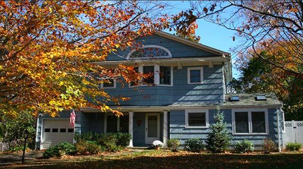 Blue colored home with white trim and gutters.